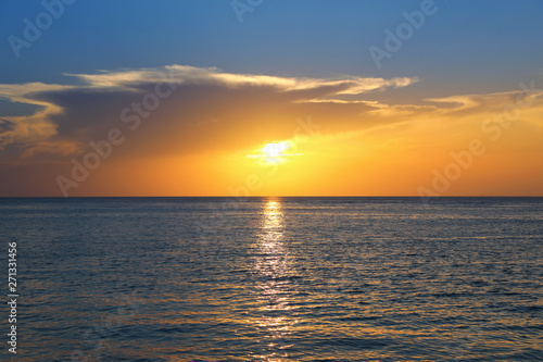 Colorful empty seascape with shiny sea over cloudy sky and sun during sunset in Cozumel  Mexico