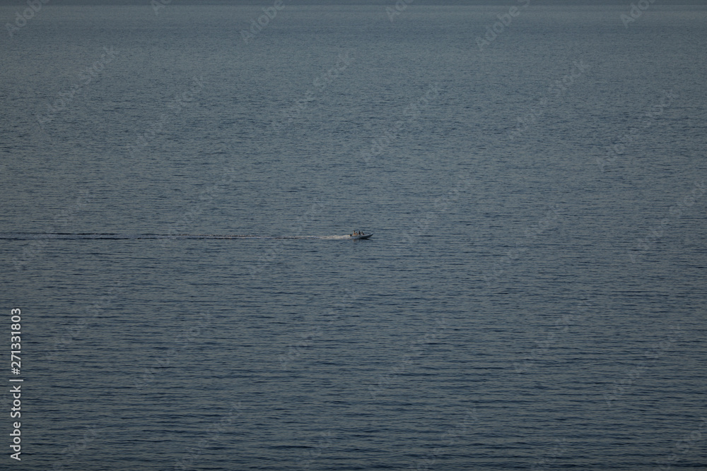 Small launch boat with people in the sea, 4 to 3 proportions Small launch boat with people in the sea, 4 to 3 proportions