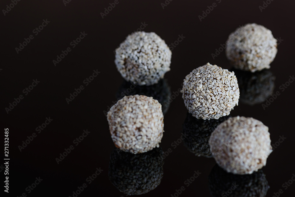 Energy balls of date fruitss and nuts. Raw dessert on a dark background. Energy balls of date fruitss and nuts. Raw dessert on a dark background.