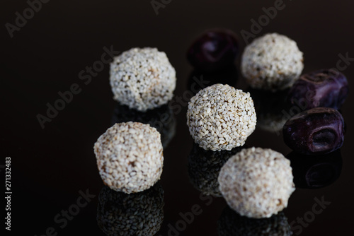 Energy balls of date fruitss and nuts. Raw dessert on a dark background. photo