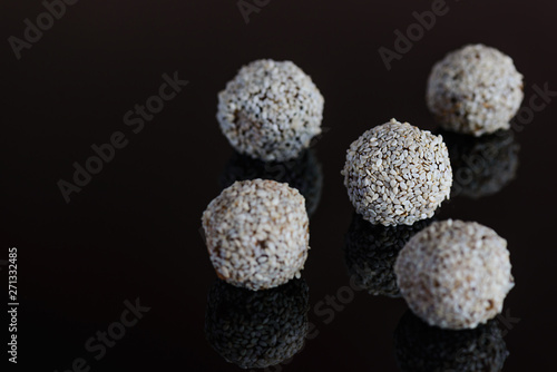 Energy balls of date fruitss and nuts. Raw dessert on a dark background.