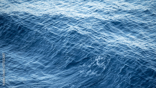 Glistening and shimmering blue ocean surface background view from the cruise liner