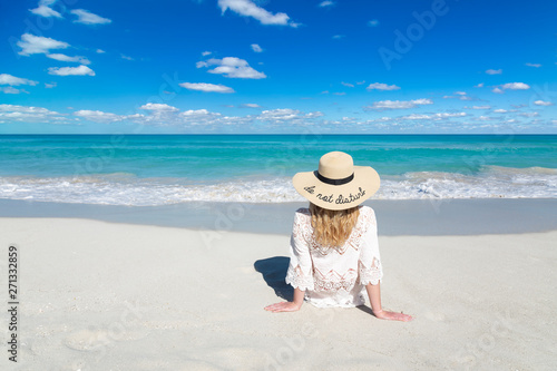 Photography Woman sits on ocean beach in Cuba, wearing hat, beautiful sky and water, Do not