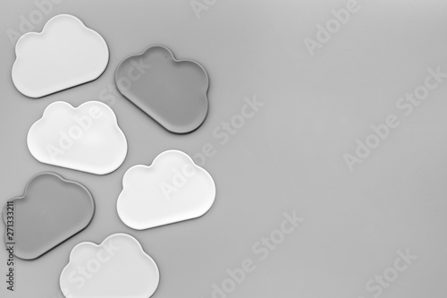 Clouds figures for cloud storage on gray background top view mockup