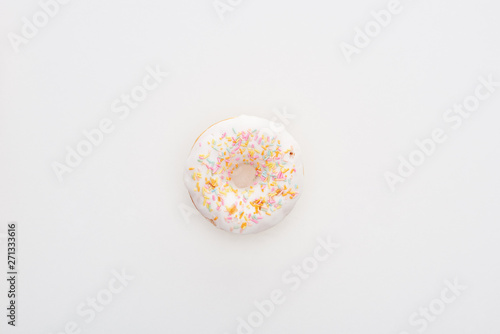 top view of glazed white doughnut with sprinkles on white background with copy space