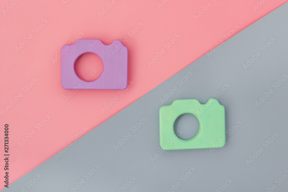 Blogger concept with photo camera on pink and gray background top view Blogger concept with photo camera on pink and gray background top view
