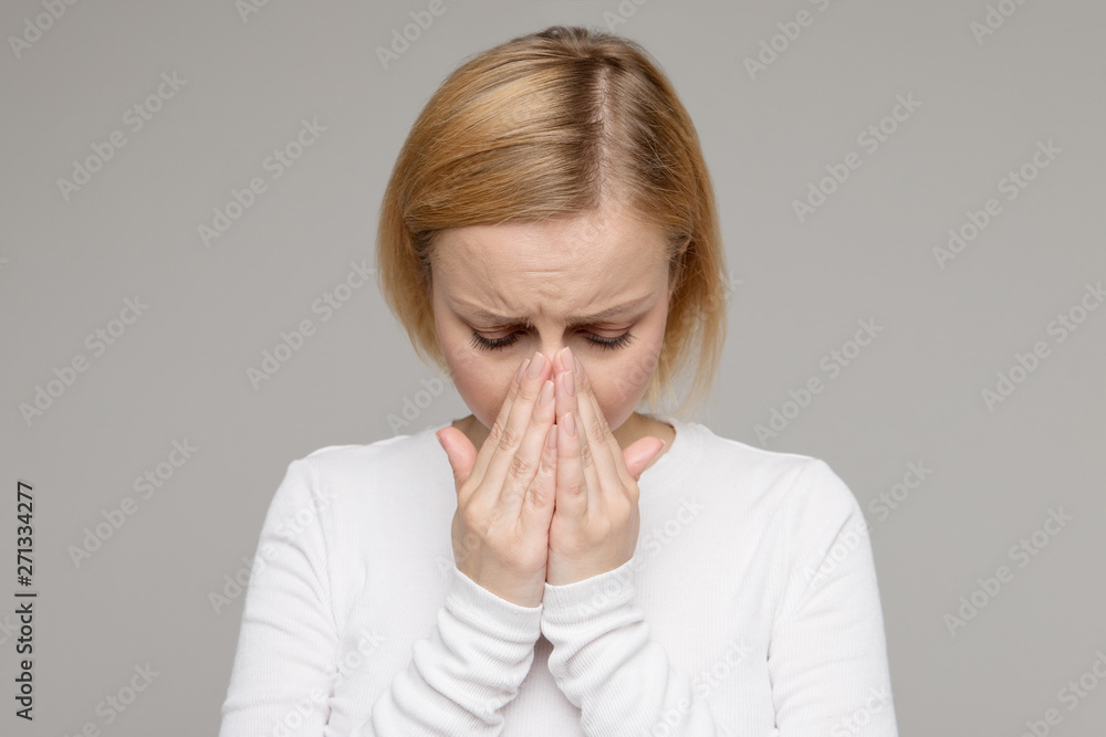 Studio portrait of sad tired woman covering her face with palms, isolated on grey background. Crying female in depression. Love relationship. Stress, bad news, sadness. Studio portrait of sad tired woman covering her face with palms, isolated on grey background. Crying female in depression. Love relationship. Stress, bad news, sadness.