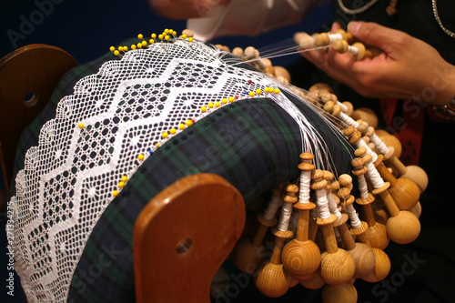 The traditional handmade production of laces in linen thread of Aosta Valley. photo