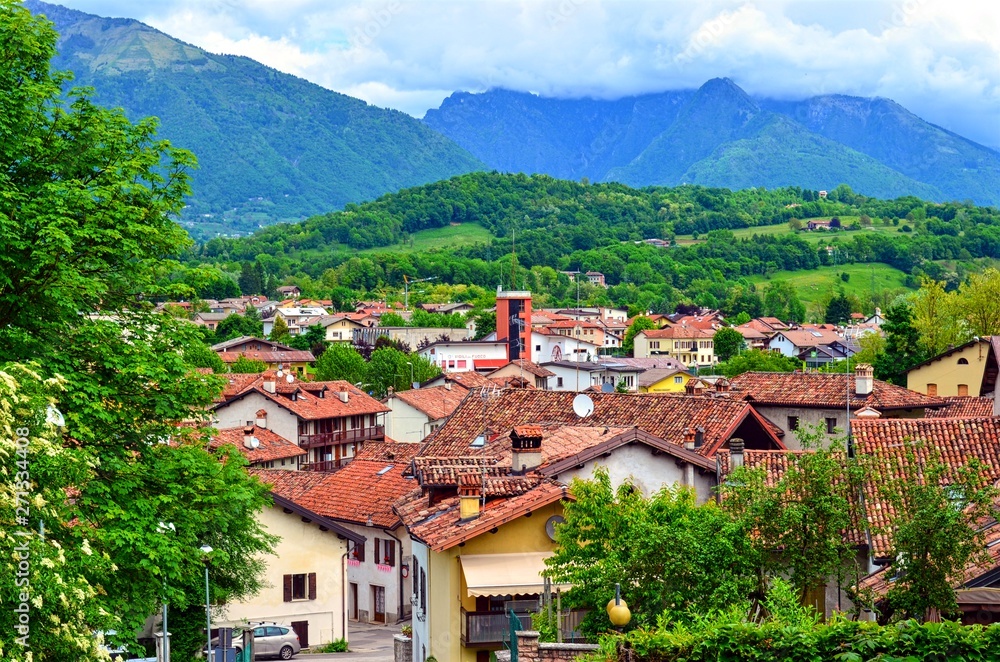 cozy provincial town with ancient terracotta tiles on the roofs of houses, located near the mountains