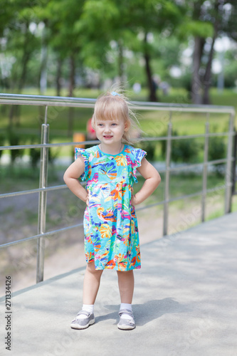 Young blond girl posing outdoors