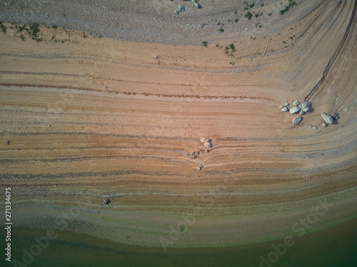 Tableau sur toile Aerial view of the Valdecañas reservoir, with green water from the algae and natural lines of the descent of the water