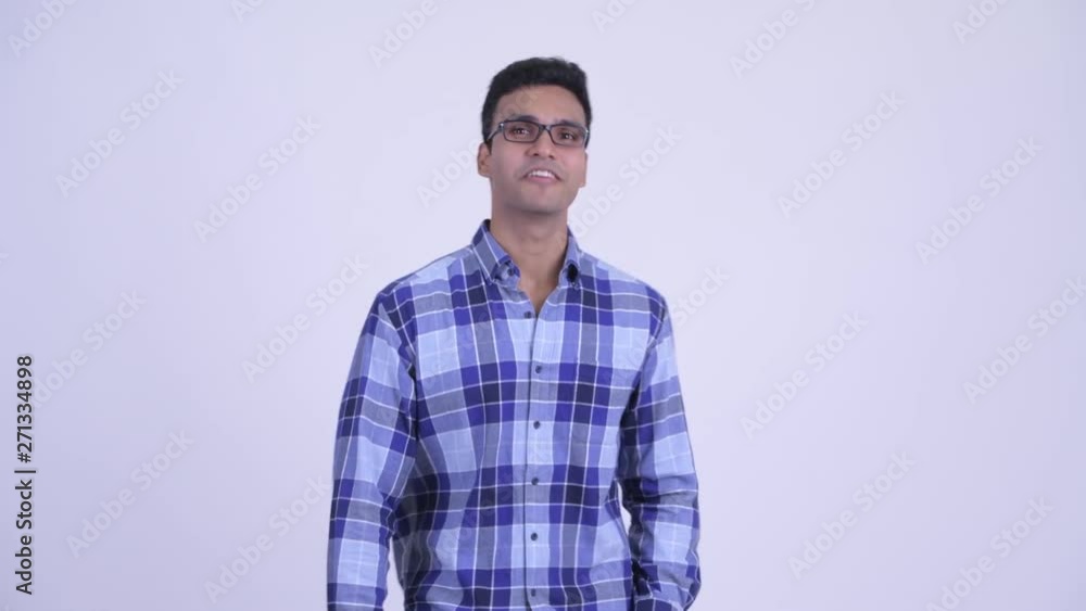Happy young Indian hipster man vlogging and talking at camera Happy young Indian hipster man vlogging and talking at camera