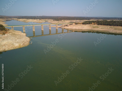 Wallpaper Mural Aerial view of the Valdecañas reservoir, with green water from the algae and natural lines of the descent of the water. Natural texture Torontodigital.ca