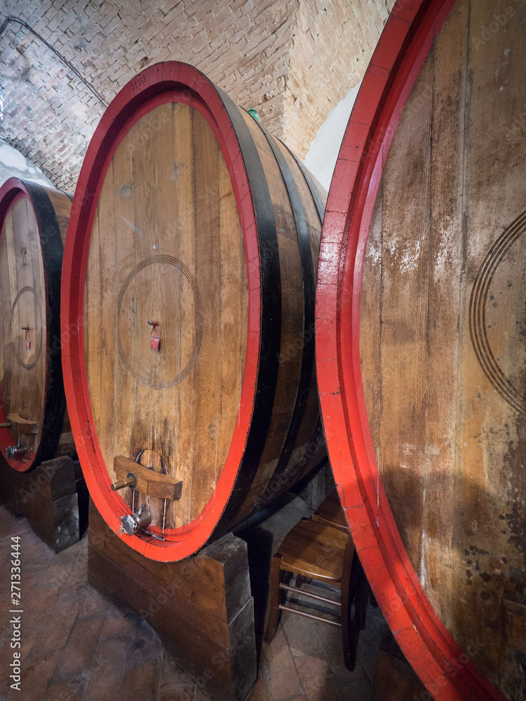 Oak barrels in an old underground wine cellar.