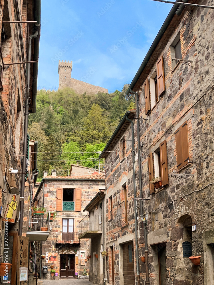 Radicofani, a medieval village with a castle and stone houses located on a Tuscan hill, Italy. Radicofani, a medieval village with a castle and stone houses located on a Tuscan hill, Italy.