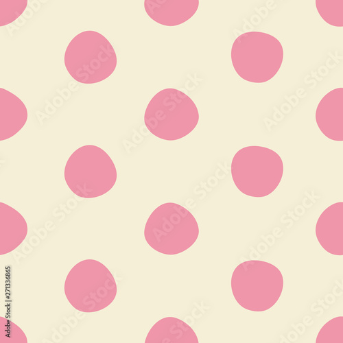 Cute pink dots seamless pattern in pink and light beige. Imperfectly round polka dot all over print design is great for fashion, textiles, wallpaper, gift wrapping paper and home decor items. Vector. 