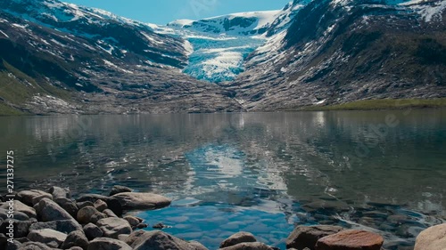 transparent glacial lake in the background of the melting glacier Svartisen in Norway photo