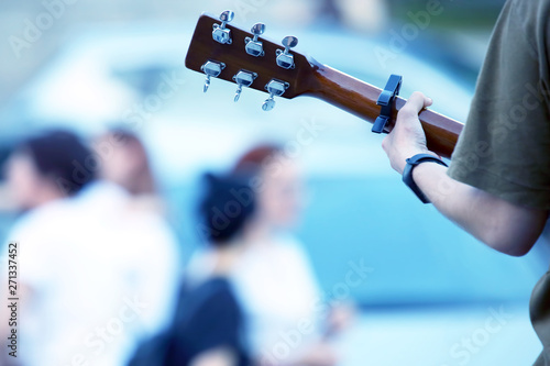 musician playing guitar on the street. music and creativity.