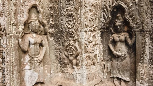 Wallpaper Mural ancient bas-reliefs depicting the divine dancer Apsara in the temple of TA Prohm. One of the most famous temples of Angkor, TA Prohm is known for its huge trees and roots growing from its walls.  Torontodigital.ca