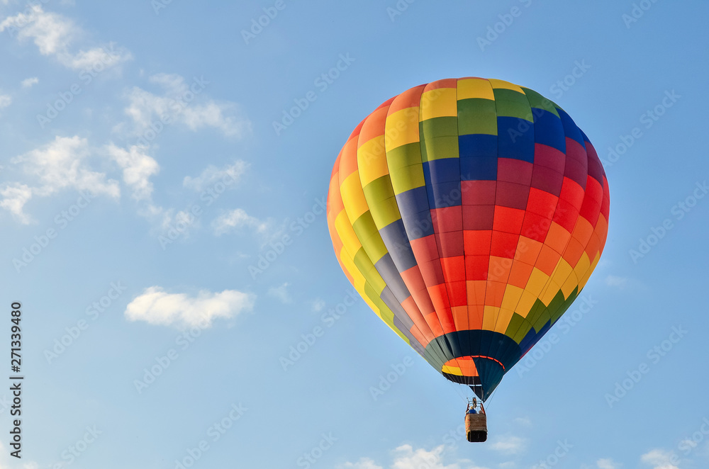 Colorful hot air balloon heading up in blue sky. Copy space. Colorful hot air balloon heading up in blue sky. Copy space.
