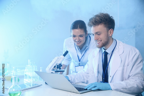 Scientists working in laboratory, space for text. Chemistry concept