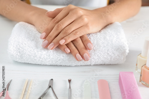 Woman waiting for manicure and tools on table, closeup. Spa treatment