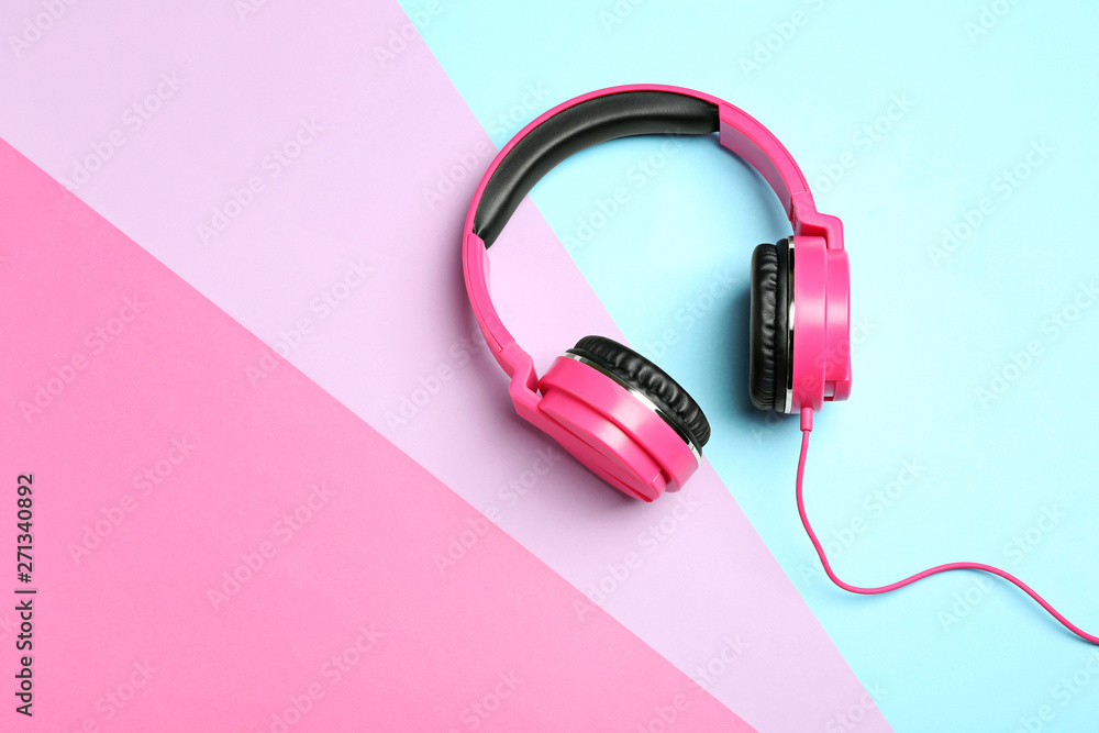 Stylish headphones on color background, top view. Space for text Stylish headphones on color background, top view. Space for text