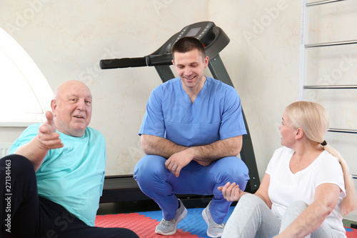 Patients with physiotherapist in modern rehabilitation center