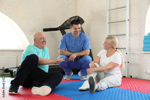 Patients with physiotherapist in modern rehabilitation center