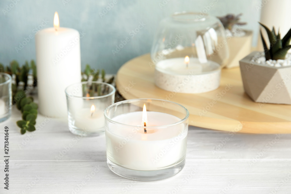Burning aromatic candle and plants on table Burning aromatic candle and plants on table