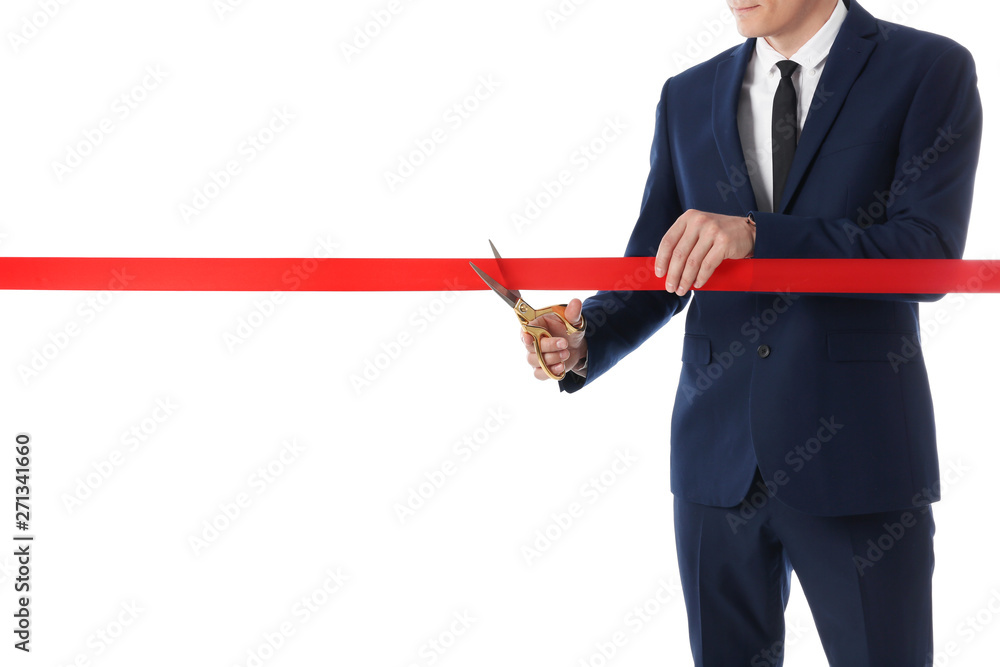 Man in office suit cutting red ribbon isolated on white, closeup Man in office suit cutting red ribbon isolated on white, closeup