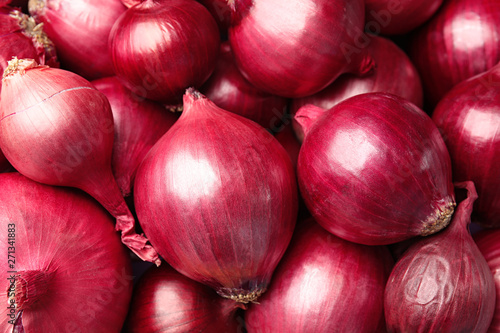 Fresh whole red onions as background, top view
