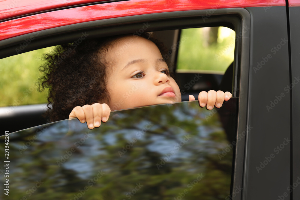 Little African-American girl alone inside car. Child in danger Little African-American girl alone inside car. Child in danger