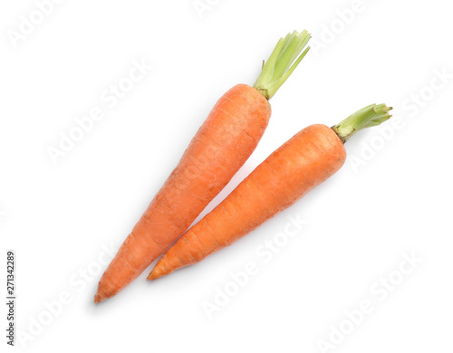 Fresh ripe carrots on white background, top view photo