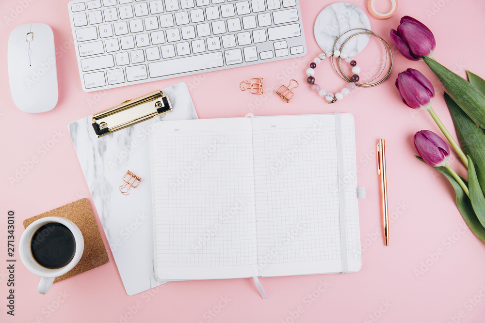 Flat lay, top view office table desk frame. Feminine desk workspace with succulent, laptop, glasses, diary and golden clips on pink background Flat lay, top view office table desk frame. Feminine desk workspace with succulent, laptop, glasses, diary and golden clips on pink background