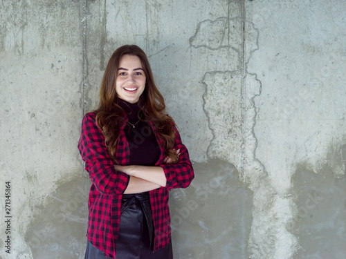 portrait of casual businesswoman in front of a concrete wall © .shock