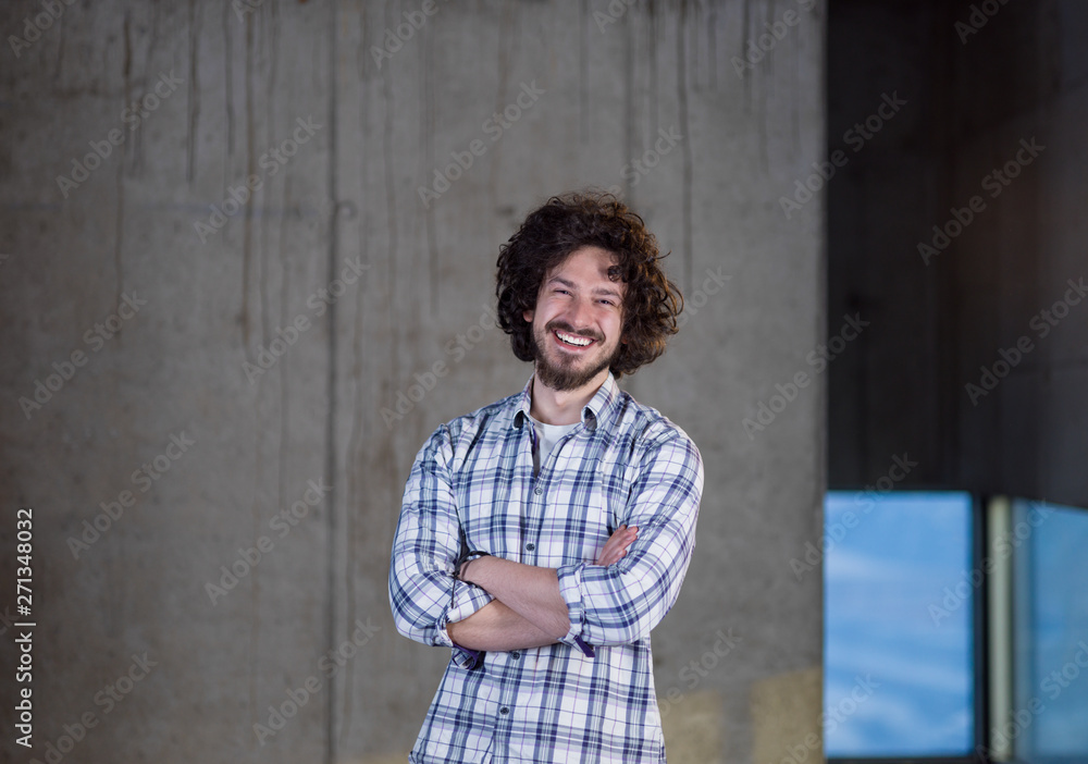 portrait of casual businessman in front of a concrete wall