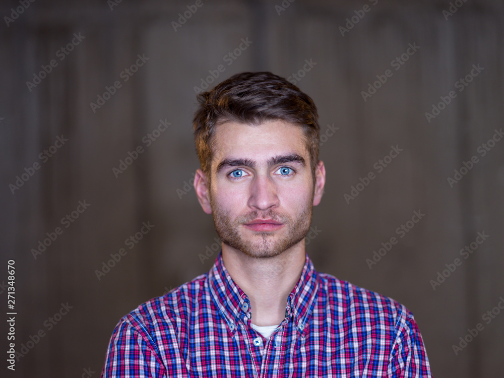 portrait of casual businessman in front of a concrete wall