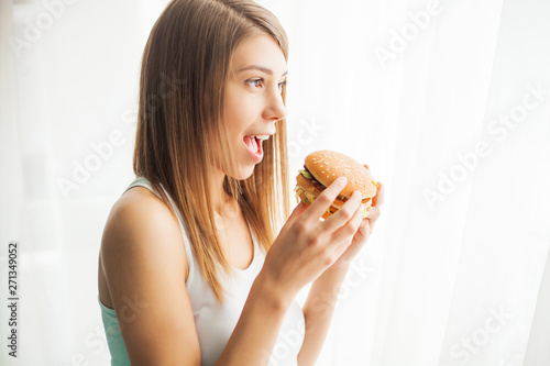 Diet. Young woman preventing her to eat junk food. Healthy eating concept