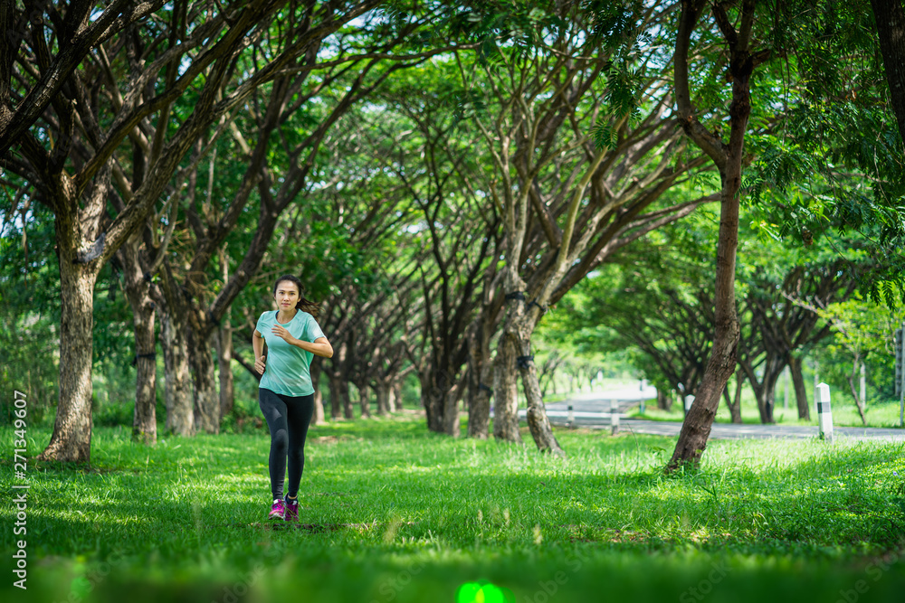 Young asian woman running on road in the nature. Young asian woman running on road in the nature.