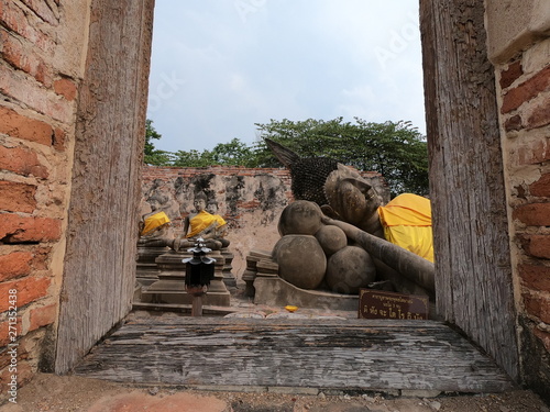 View of Buddha statues through the window in the ancient temple Wat Phutthaisawan in Ayutthaya Thailand. photo