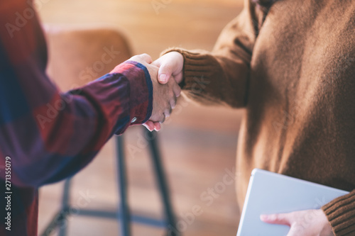Closeup image of two people shaking hands