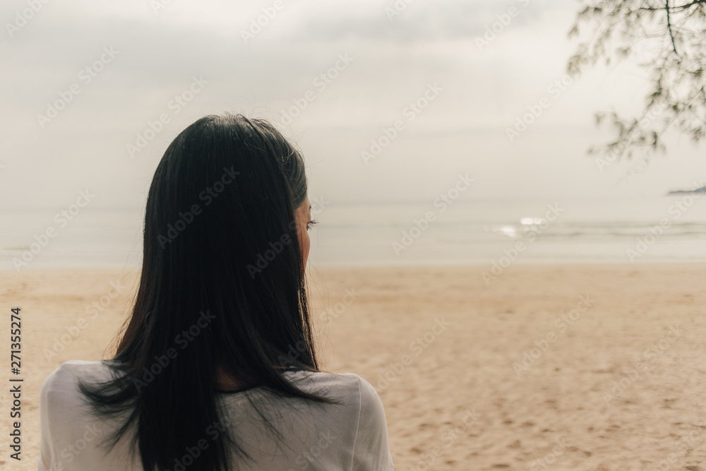 Lonely woman stand on the beach and look into the sea. Lonely woman stand on the beach and look into the sea.