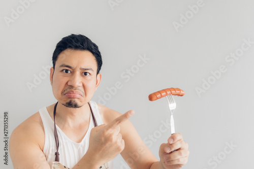 Hate face of man denied to eat sausage. Concept of hate and diet.