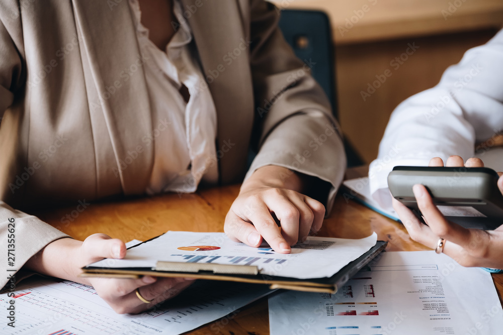 Close up Businessman and partner using calculator for calaulating finance, tax, accounting, statistics and analytic research concept Close up Businessman and partner using calculator for calaulating finance, tax, accounting, statistics and analytic research concept