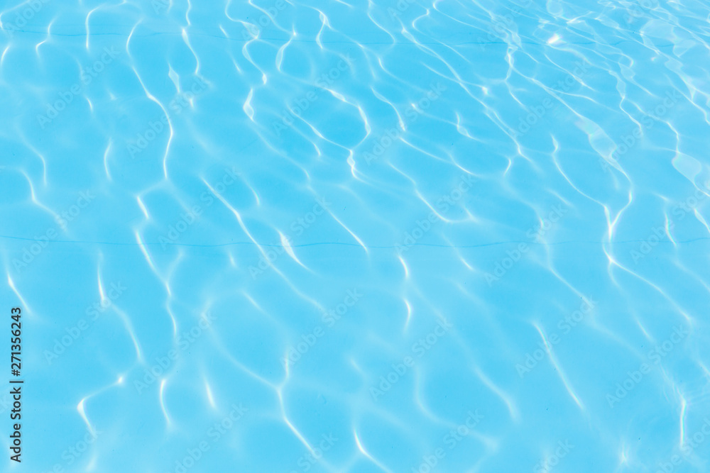 Fototapeta premium Blue pool water with sun reflections
