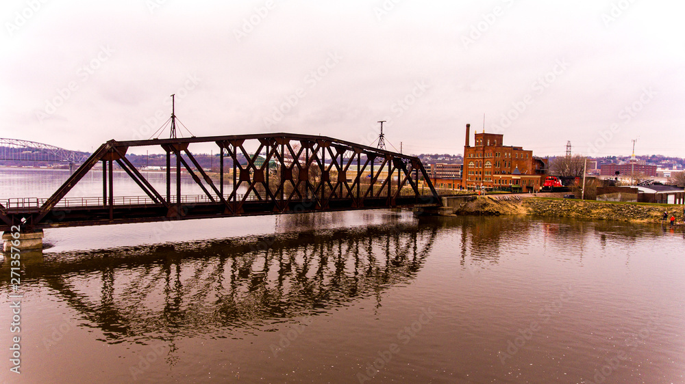 Flooded Mississippi River Railroad Bridge crosses near Brewery
