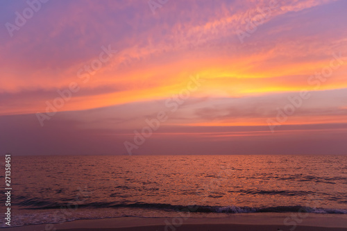 Sunset on a beach with colorful sky in twilight time.