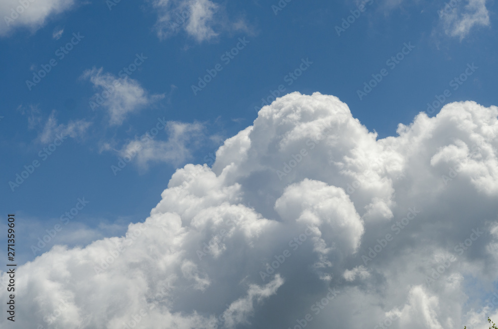 A large fluffy white cloud in the sky A large fluffy white cloud in the sky
