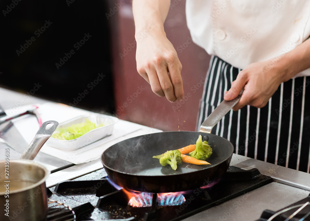 Chef preparing food in the kitchen, chef cooking, closeup